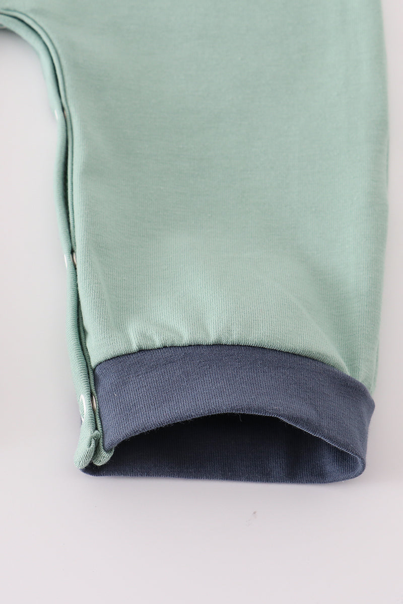 Close-up of a green garment with a blue lining on a white background