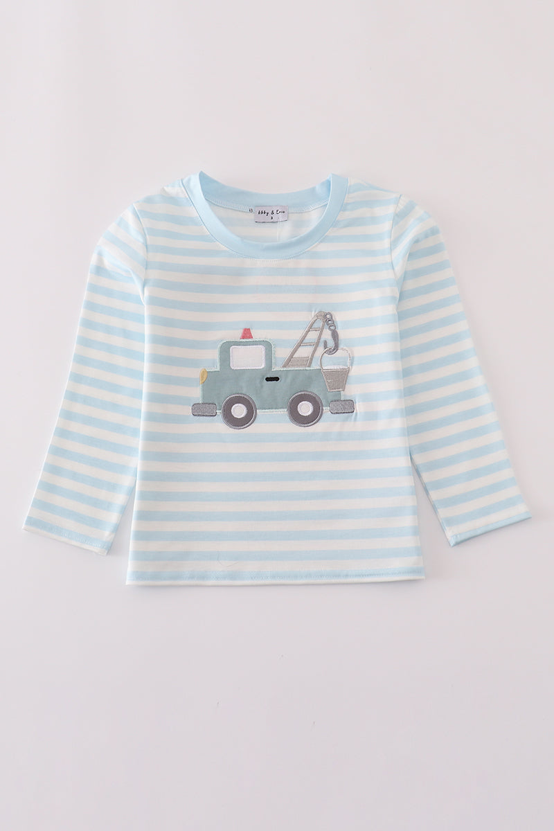 Striped long-sleeve shirt with a tow truck design on a light gray background