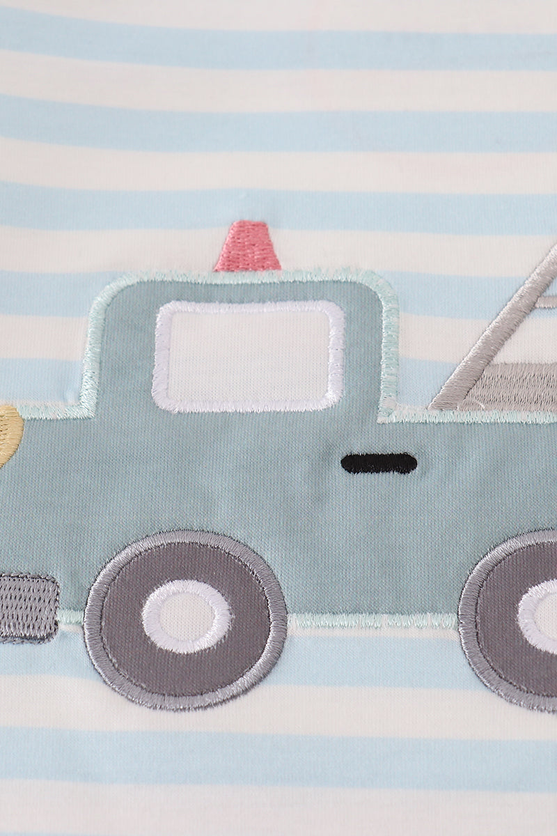 Children's rug with a blue truck design on a striped background
