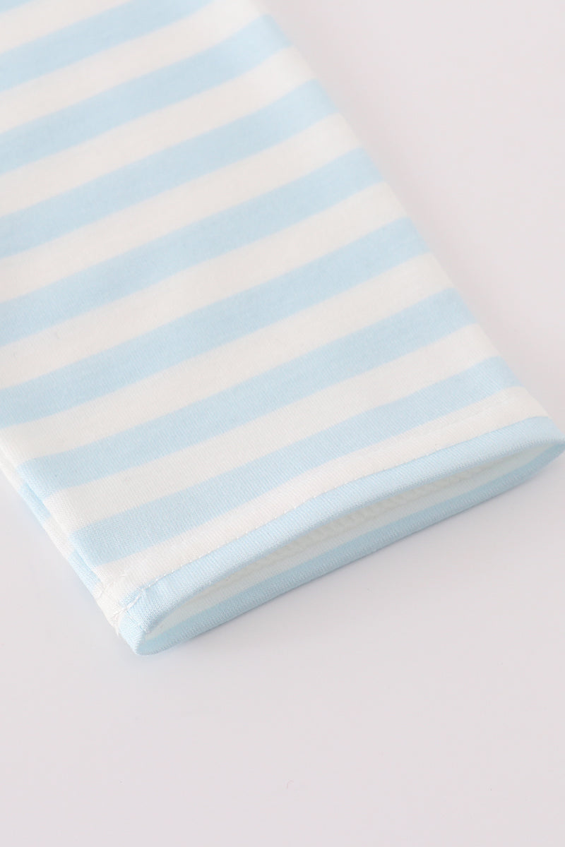 Striped fabric with light blue and white stripes on a light gray background