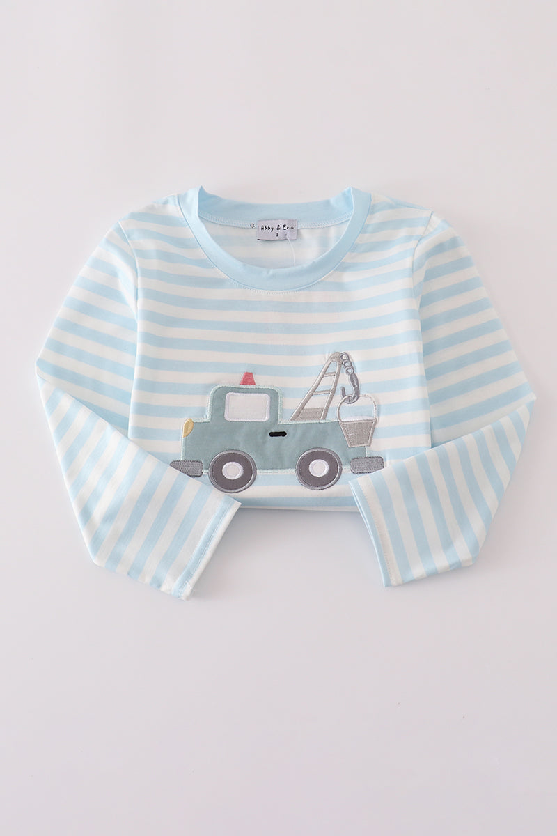 Striped long-sleeve shirt with a tow truck design on a light gray background