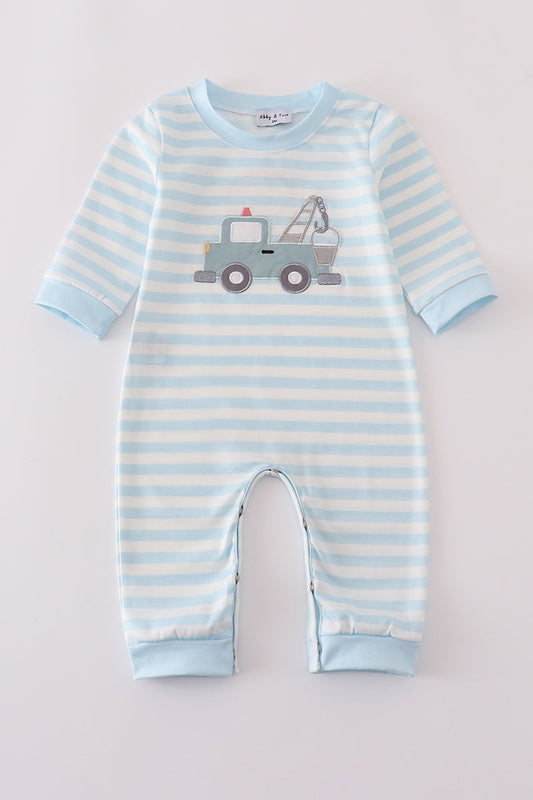 Blue and white striped baby romper with a toy truck design on a light gray background