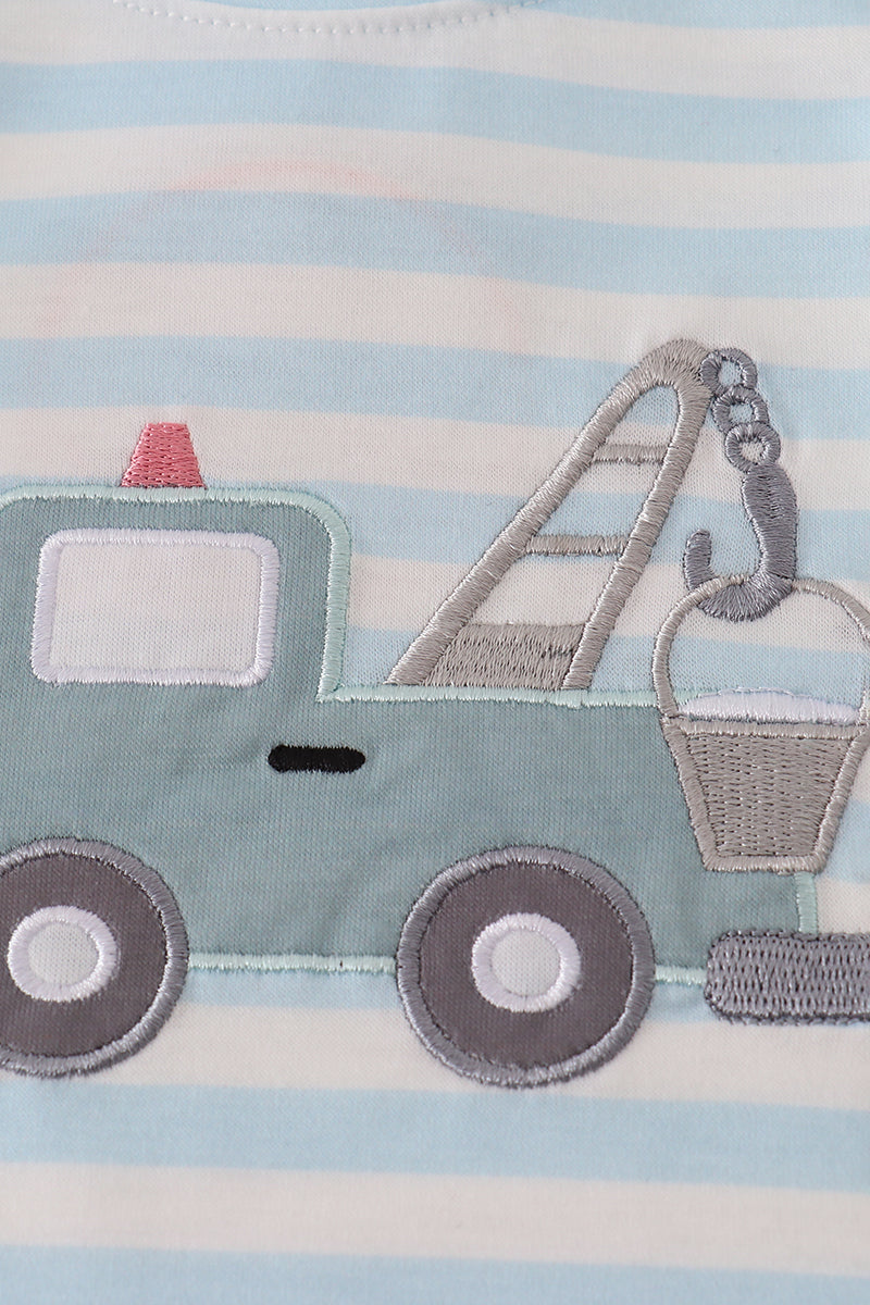 Close-up of a children's towel with a tow truck design on a striped background