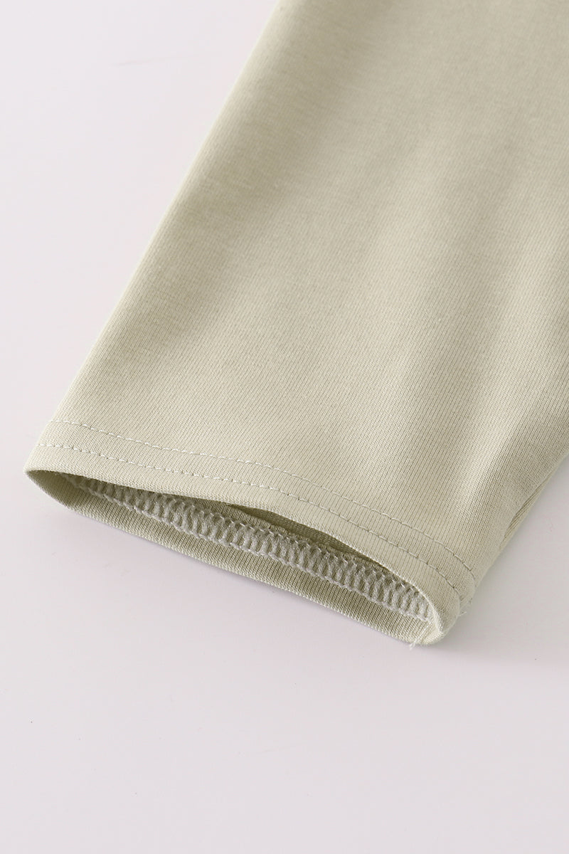 Close-up of a green fabric edge on a white background
