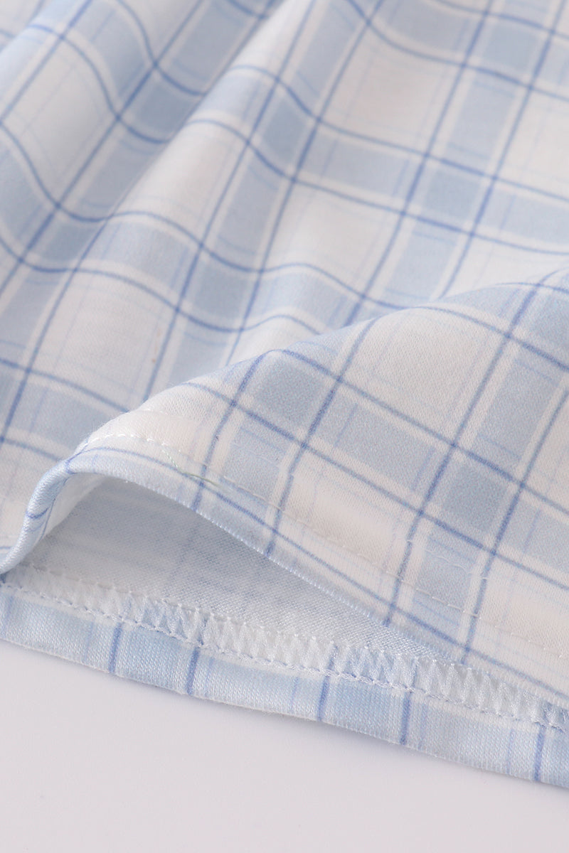 Close-up of blue and white checkered fabric with a white background