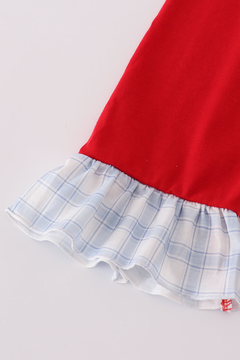 Red dress with a plaid hem on a light gray background