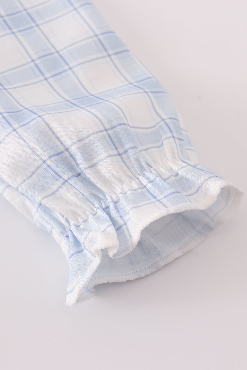 Blue and white checkered fabric on a light gray background