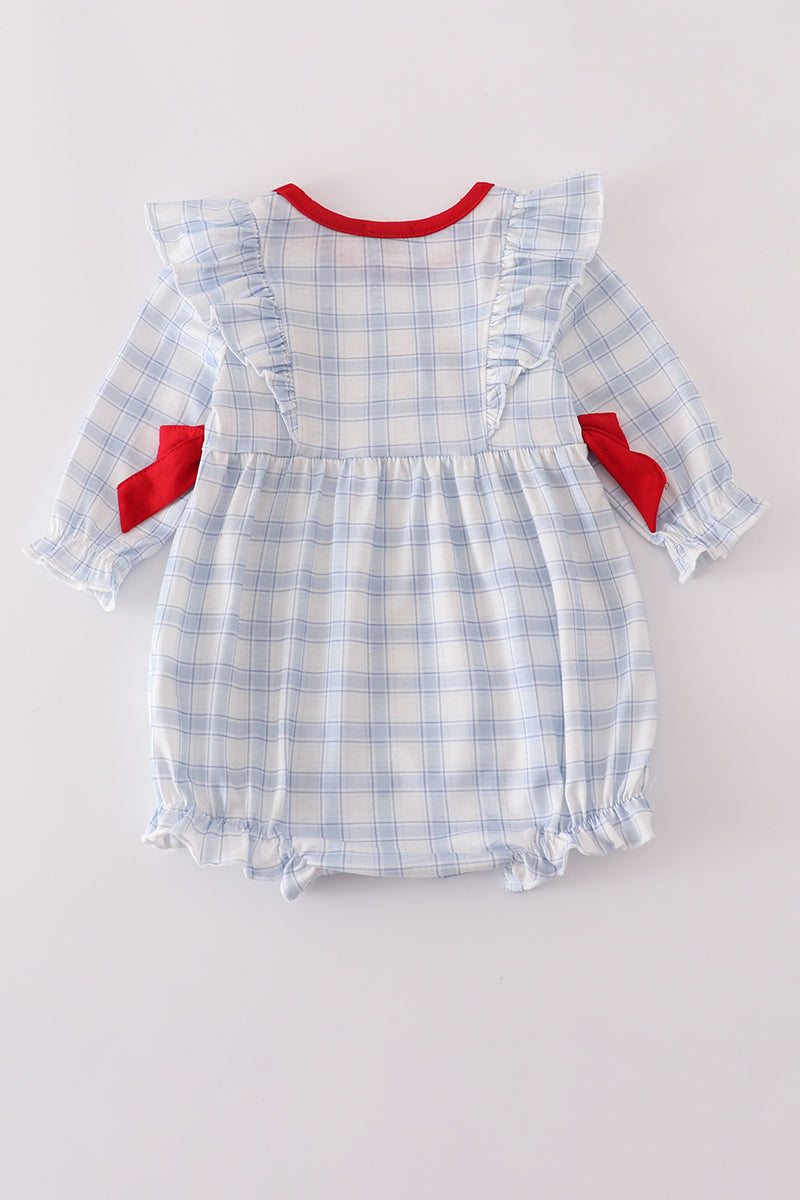 Baby romper with blue plaid pattern and red accents on a light gray background