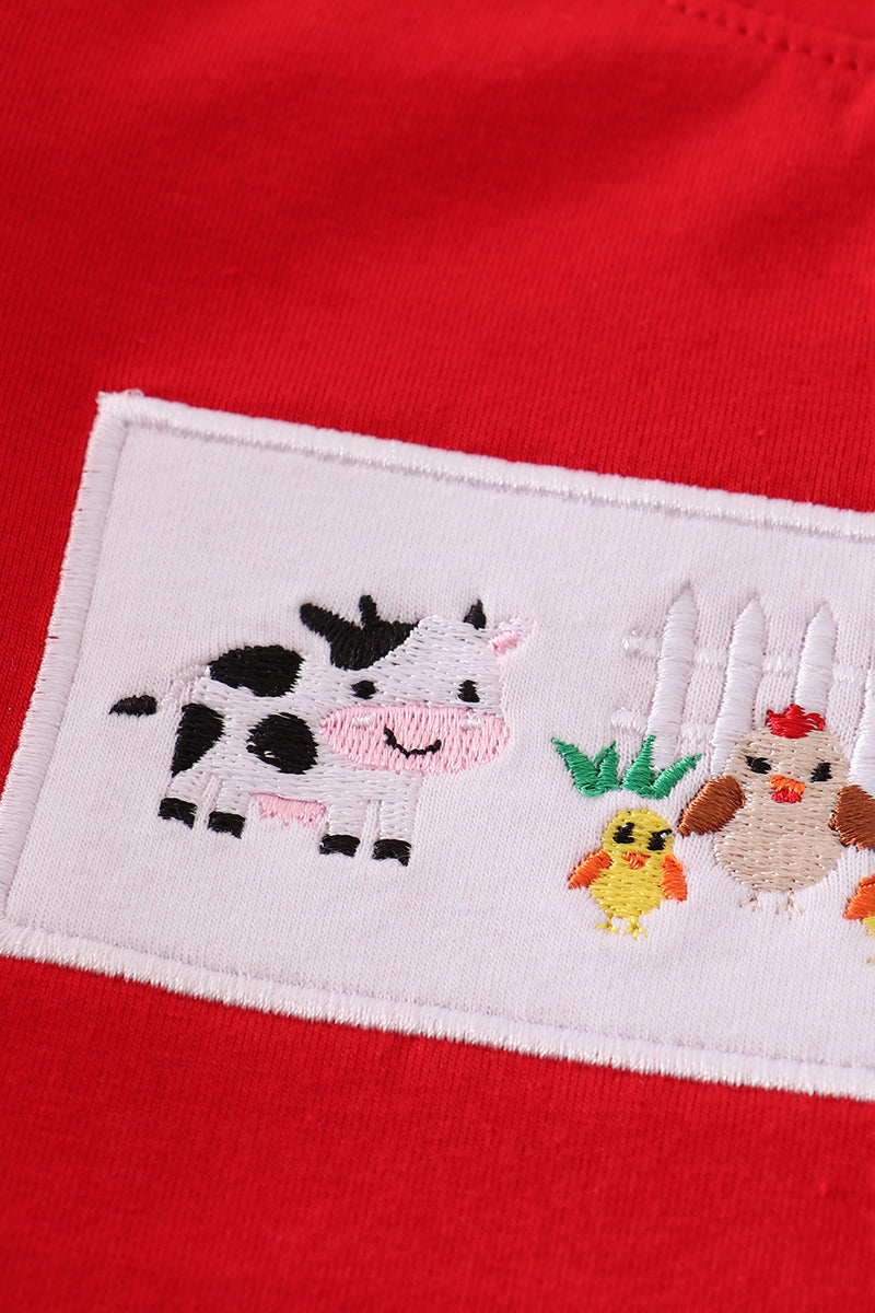 Embroidered patch with a cow, chicken, and duck on a red background