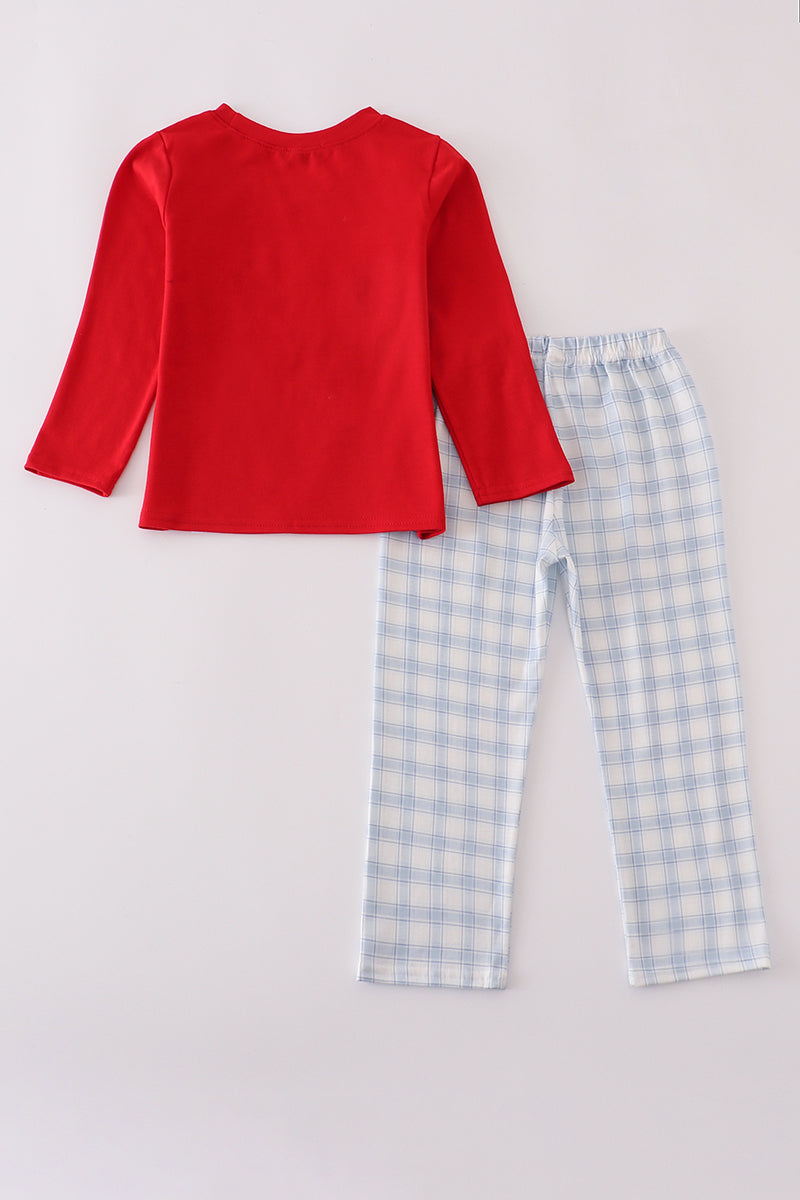Red long-sleeve top and blue checkered pants on a light gray background