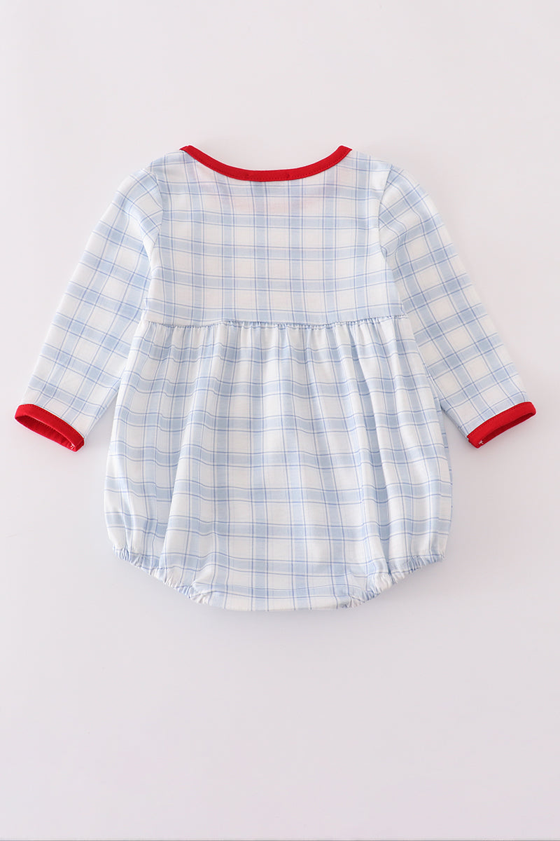Blue and white checkered baby romper with red trim on a light gray background
