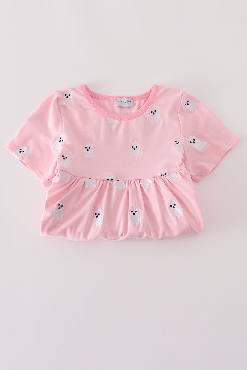 Pink top with animal print on a light gray background