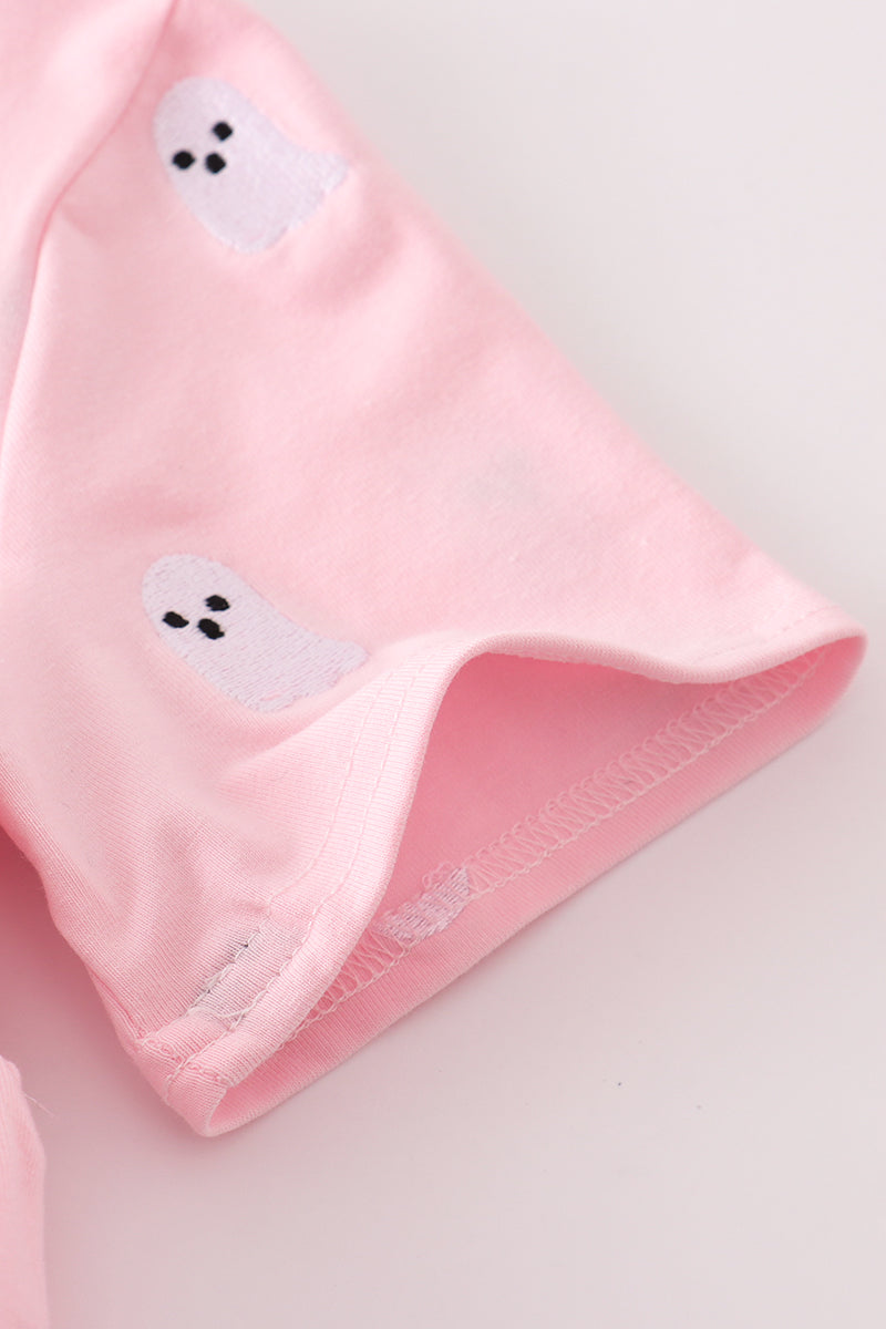 Pink fabric with ghost designs on a light gray background