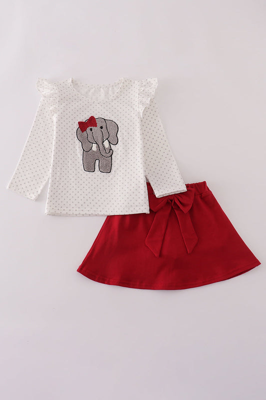 Children's outfit with white top featuring an elephant design and red skirt on a light gray background