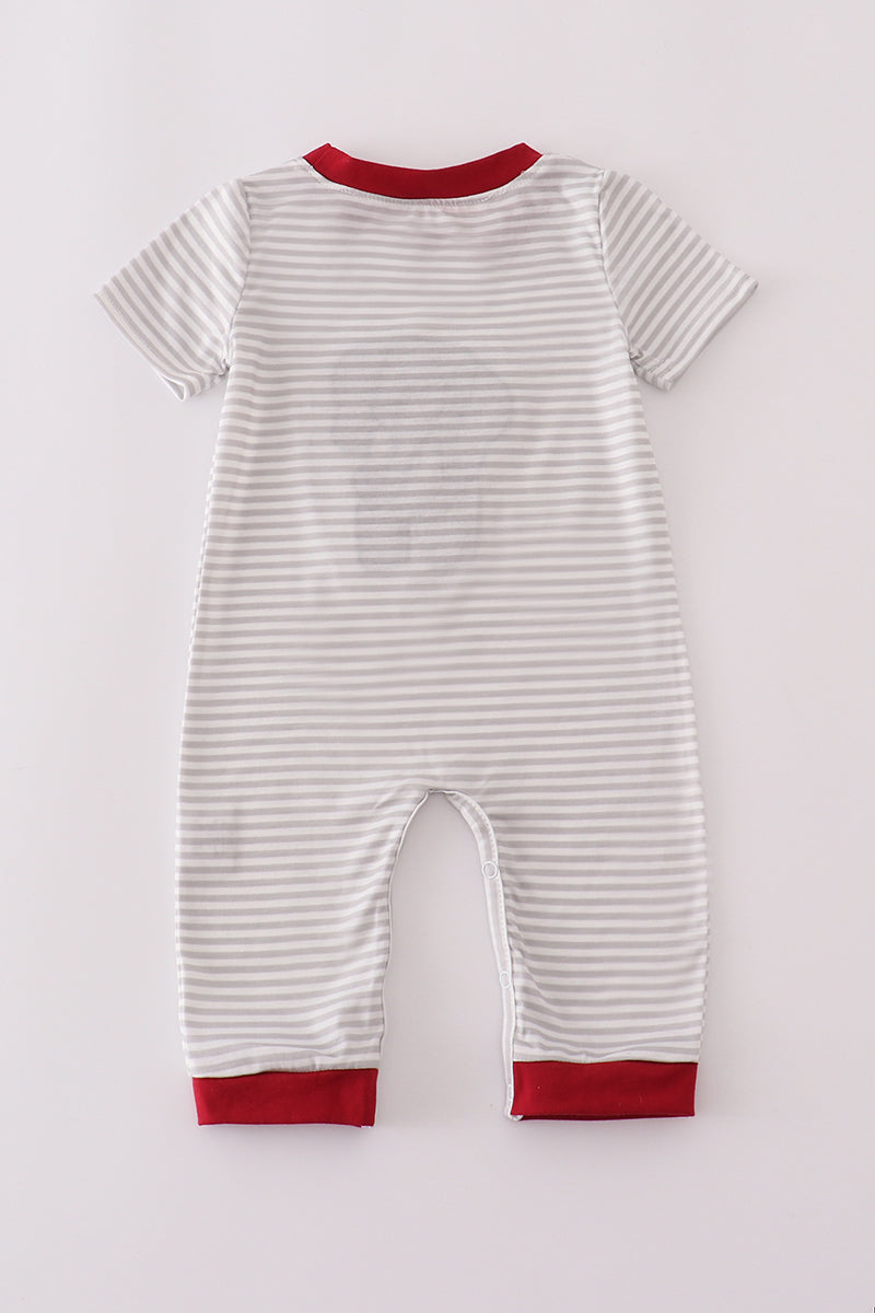 Striped baby romper with red trim on a light gray background