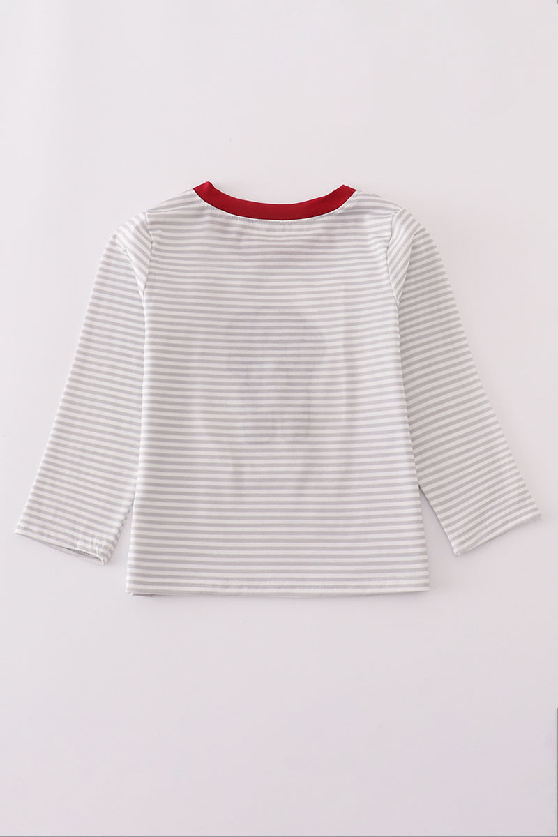 Striped shirt with red neckline on a light gray background