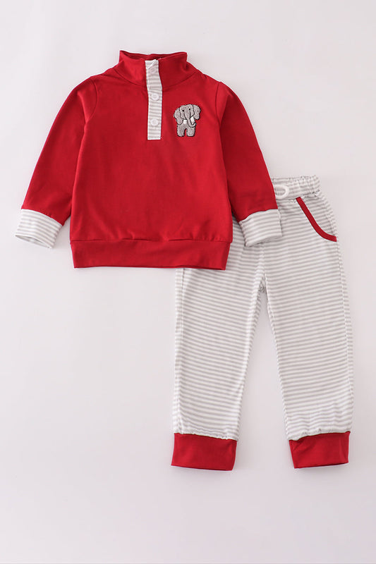 Red and white children's outfit with a matching hat on a light gray background