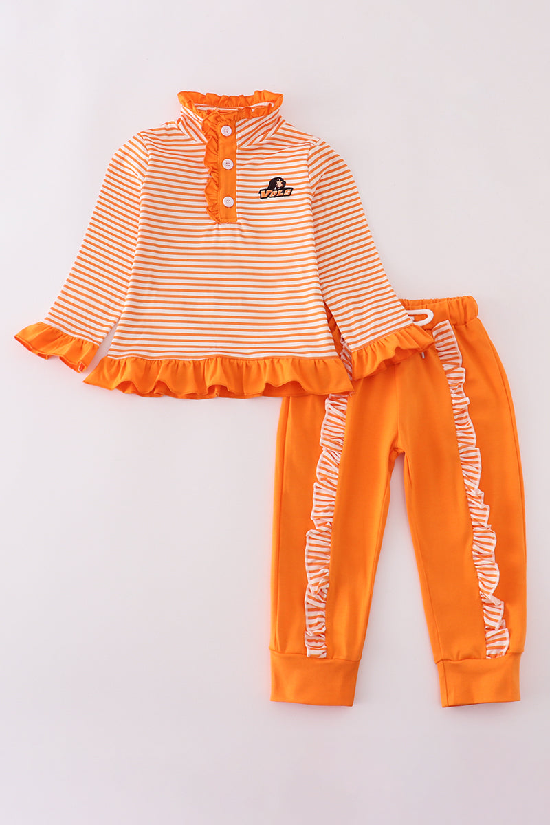 Children's outfit with striped top and orange pants on a light gray background