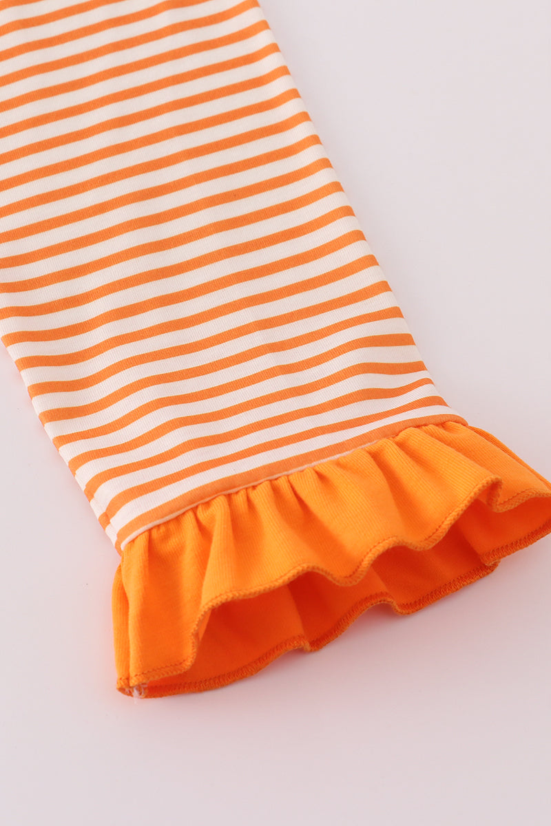 Orange and white striped fabric with ruffled bottom edge on a light gray background