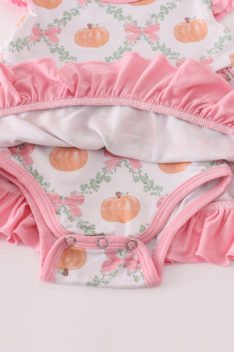Baby outfit with pink ruffled trim and pumpkin pattern on a white background
