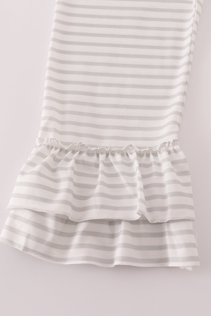 Striped dress with ruffled hem on a light gray background