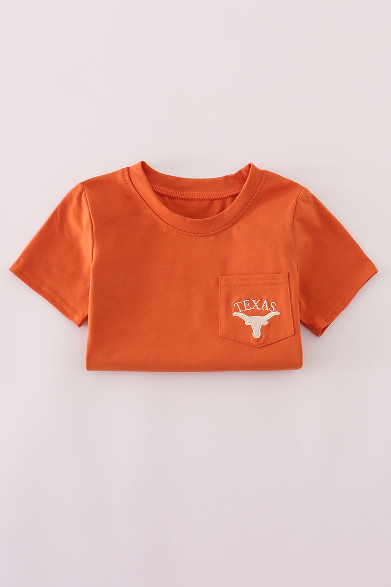 Orange t-shirt with a pocket and 'Texas' logo on a light gray background