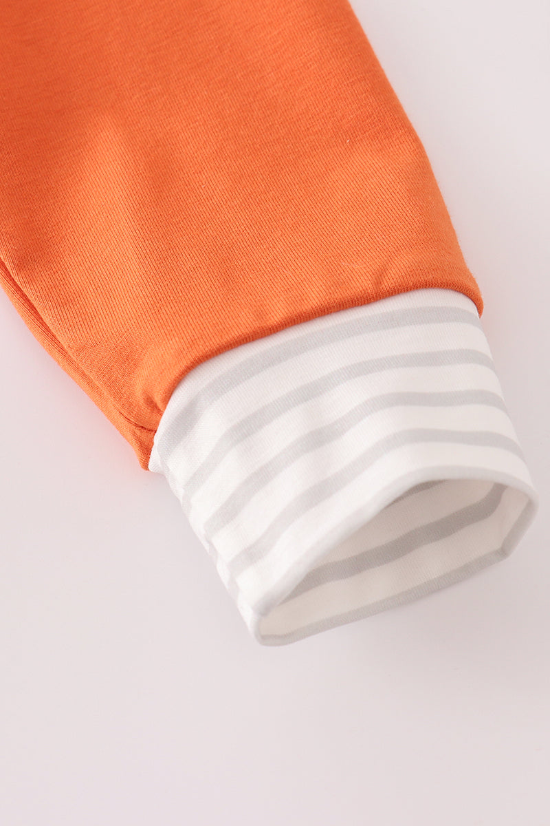 Close-up of an orange and white sleeve on a light gray background