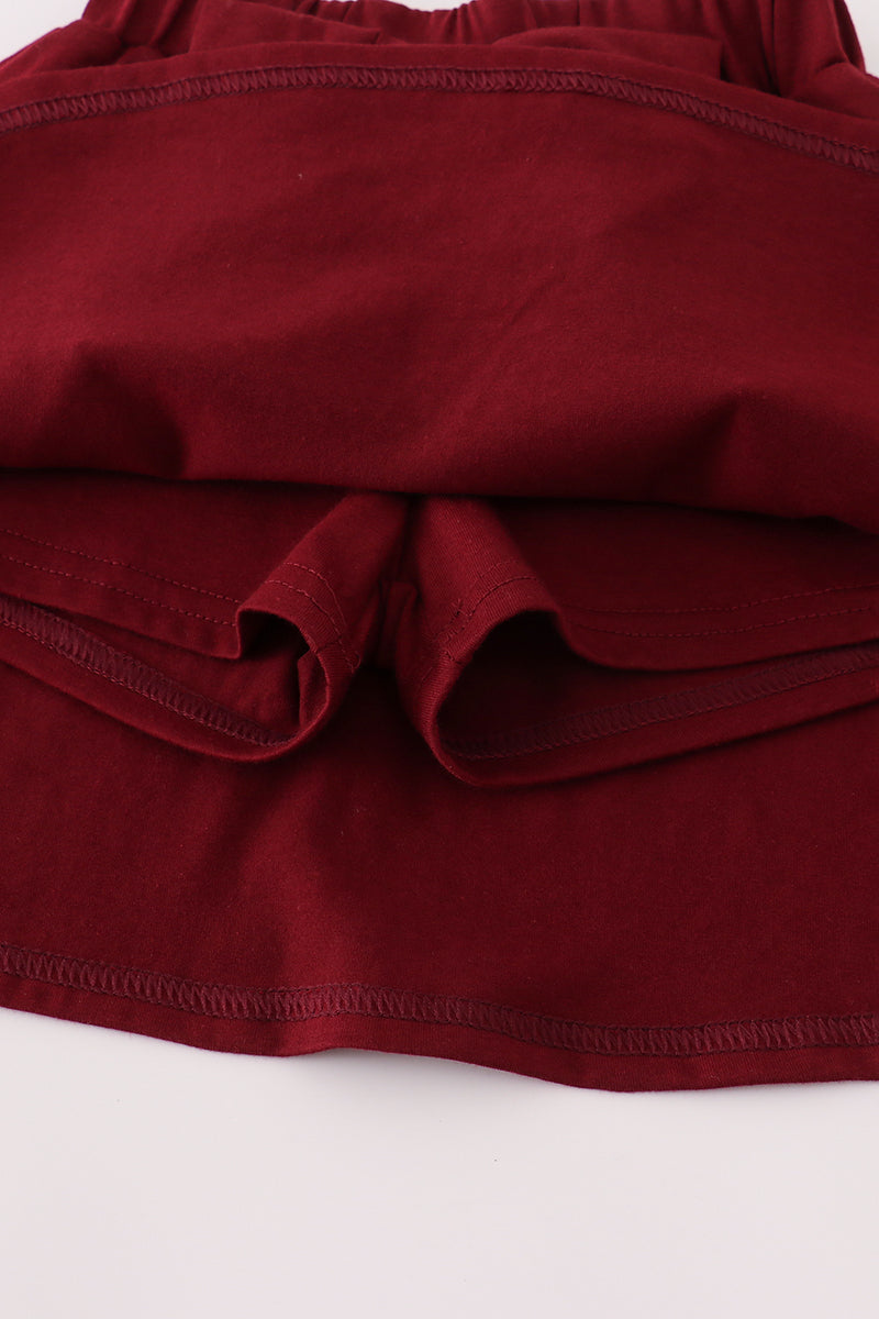 Folded burgundy fabric on a white background