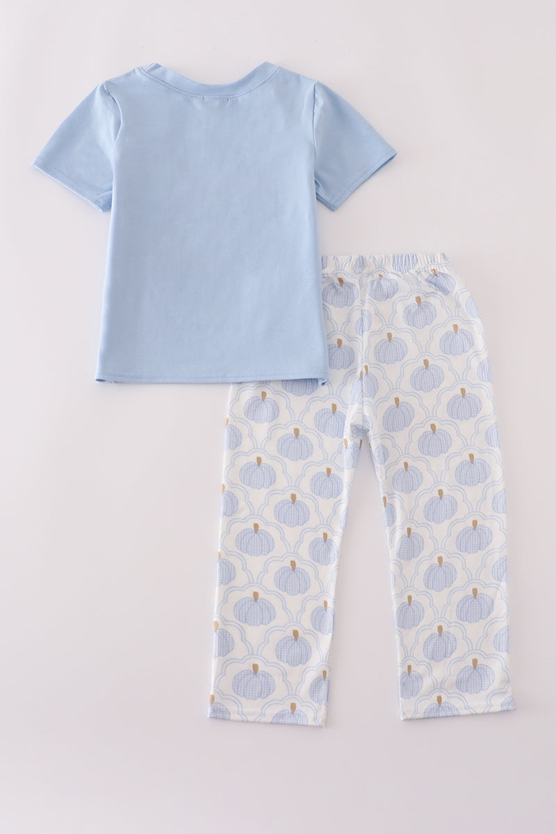 Light blue pajama set with patterned pants on a light gray background