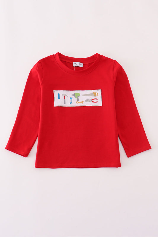 Red long-sleeve shirt with a colorful graphic on a white background
