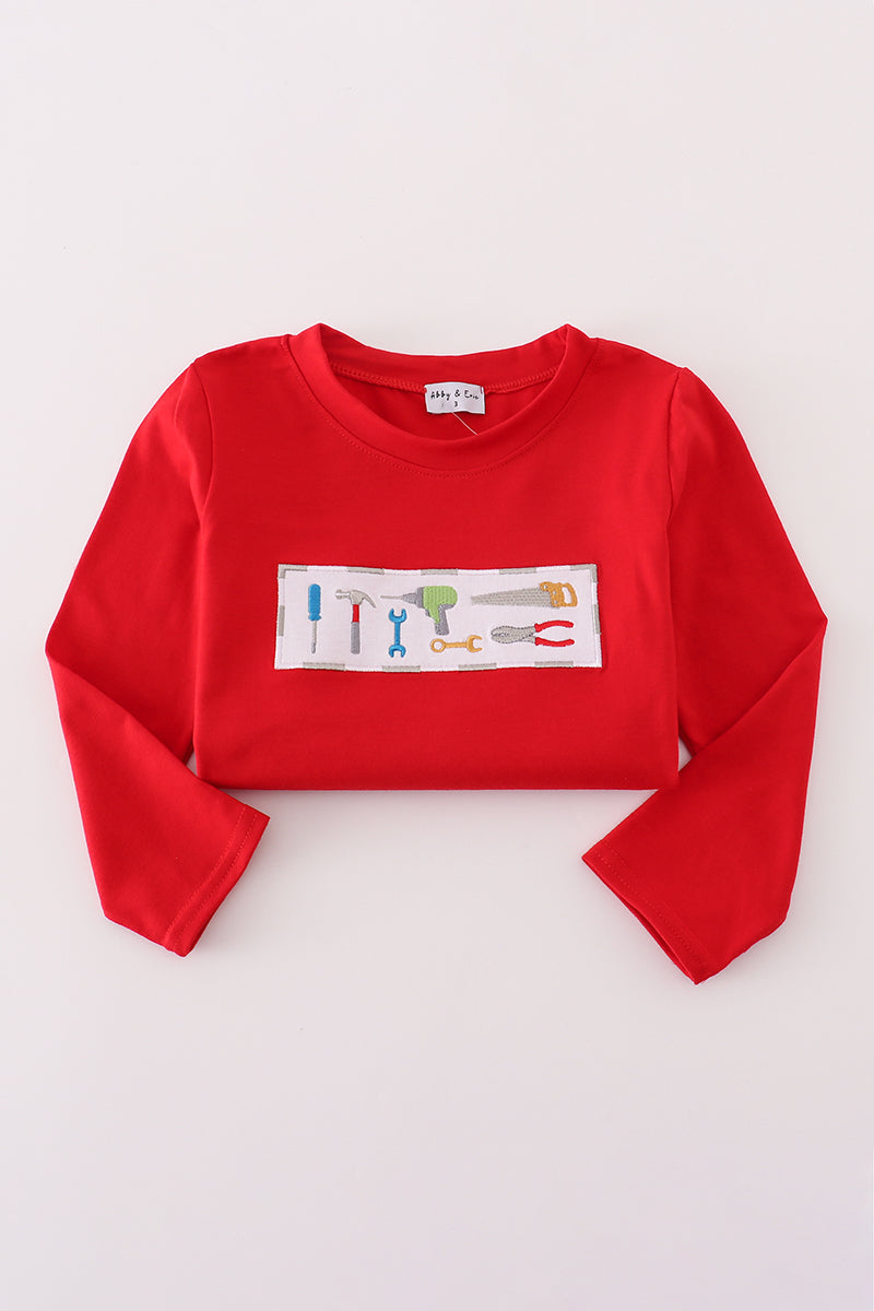 Red long-sleeve crop top with a colorful graphic on a light gray background