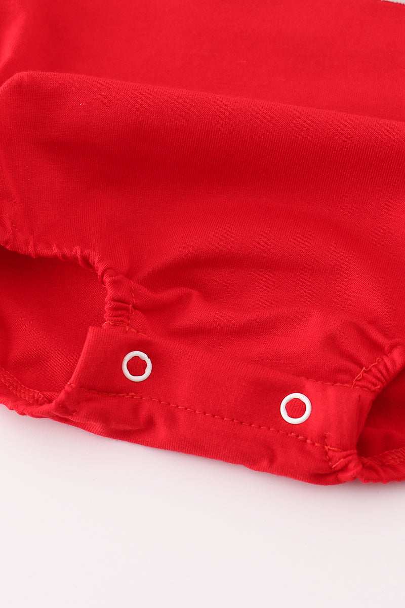 Close-up of a red fabric with white buttons on a white background