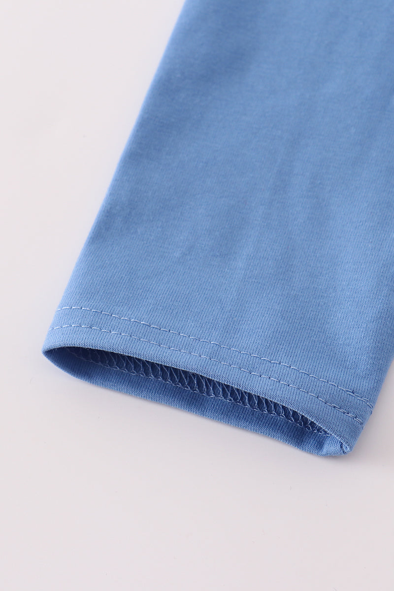 Close-up of a blue fabric edge on a light gray background