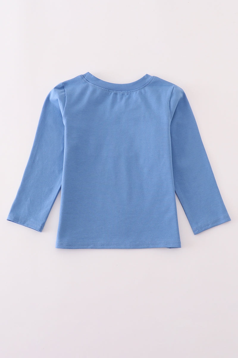 Blue long-sleeve shirt on a light gray background