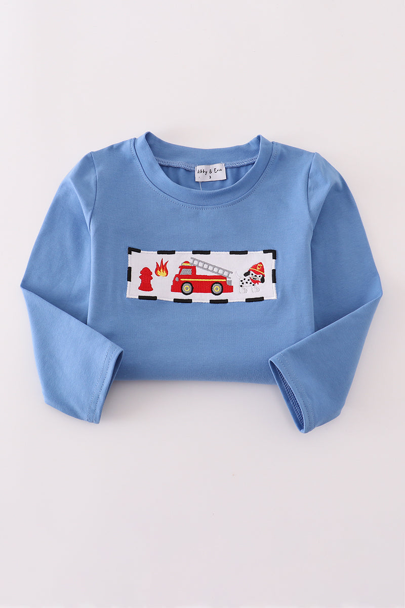 Blue sweatshirt with a fire truck design on a white background
