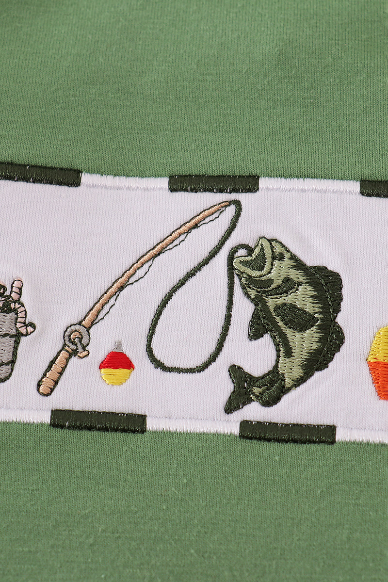 Close-up of a green shirt with fishing-themed embroidery on a white background