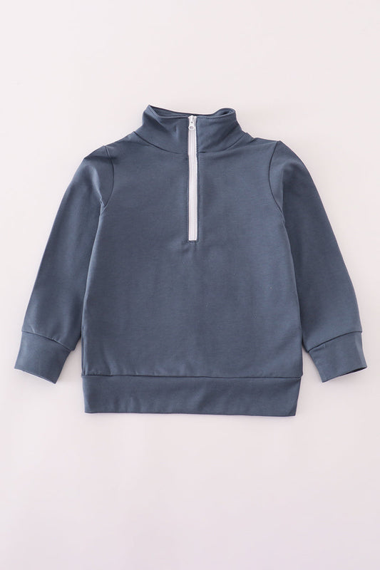 Blue sweatshirt with a white zipper on a light gray background