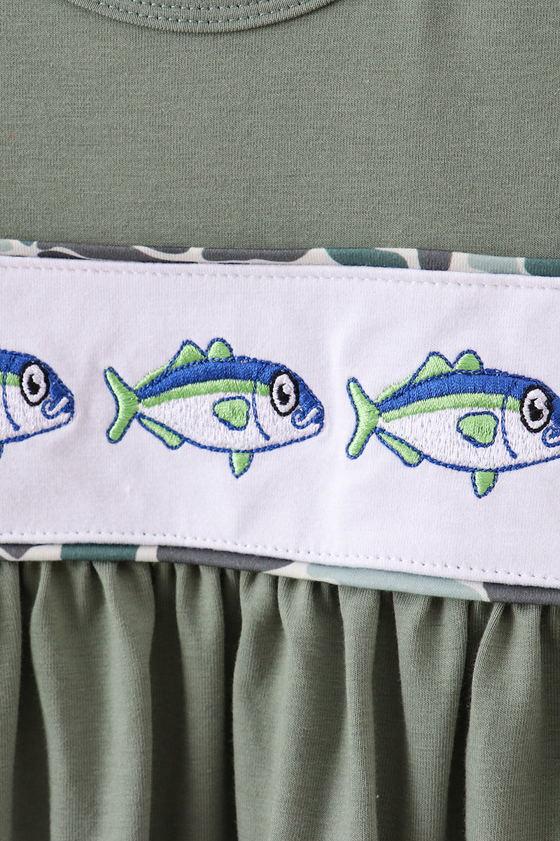 Green dress with embroidered fish design on a white band