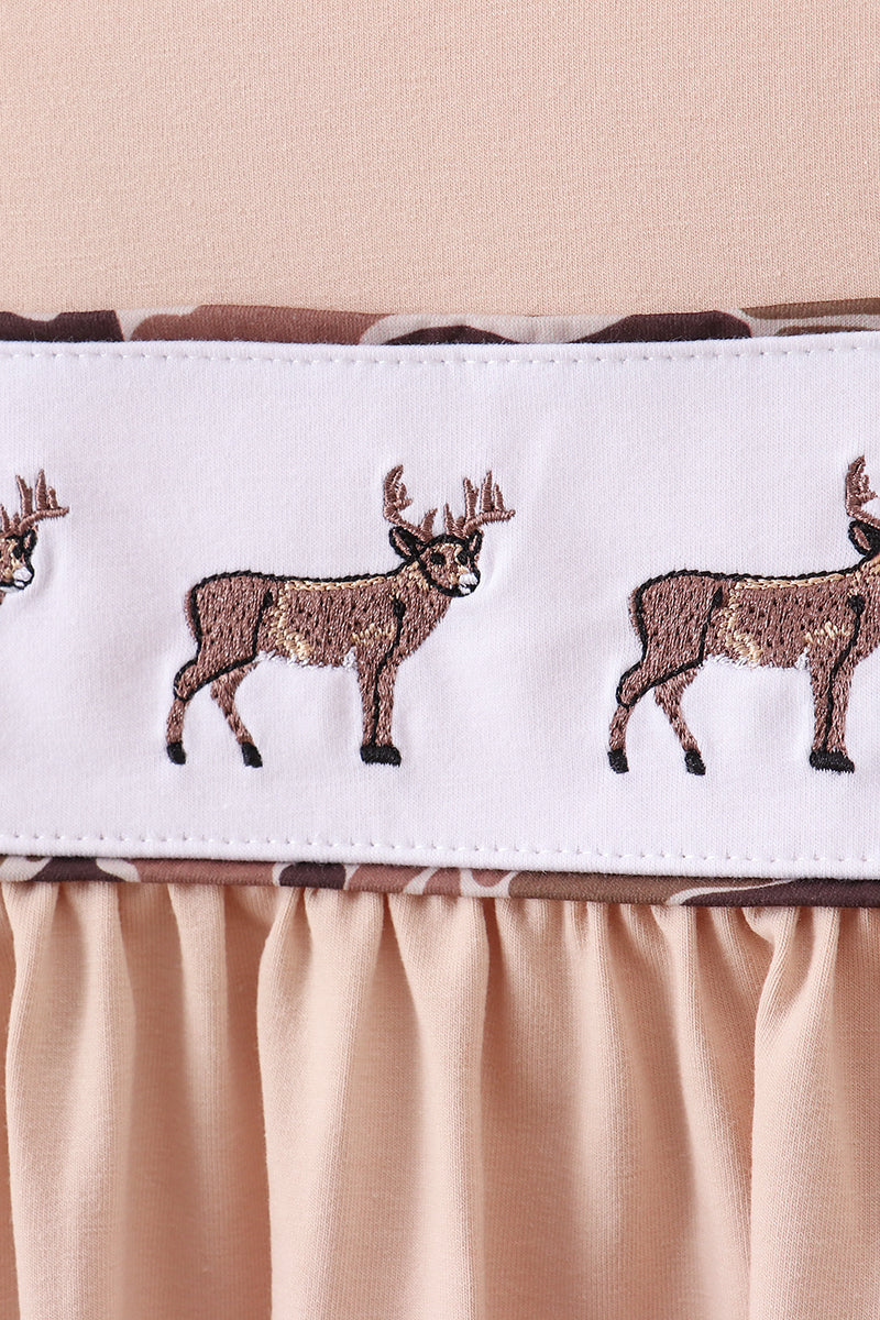 Embroidered deer pattern on a white border with a pink background
