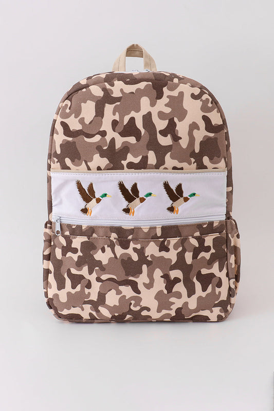 Camouflage-patterned backpack with embroidered designs on a white background