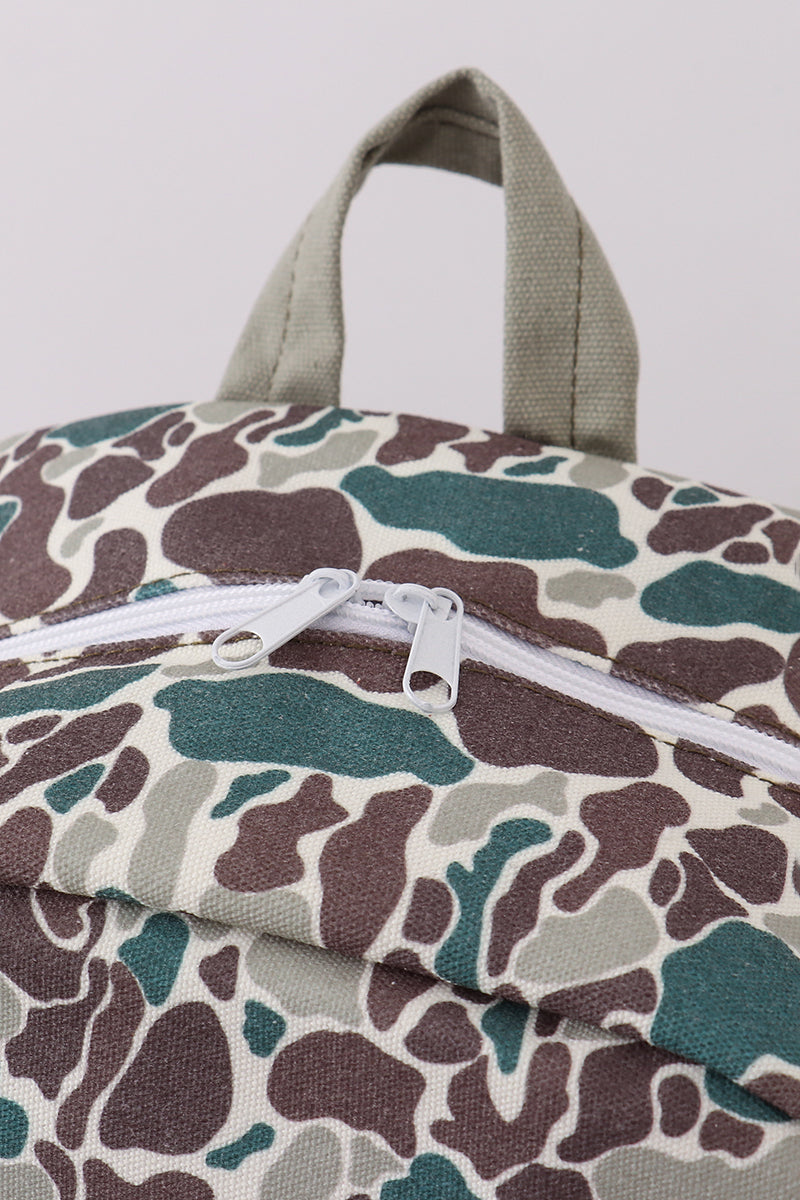 Camouflage-patterned bag with a white zipper on a light gray background