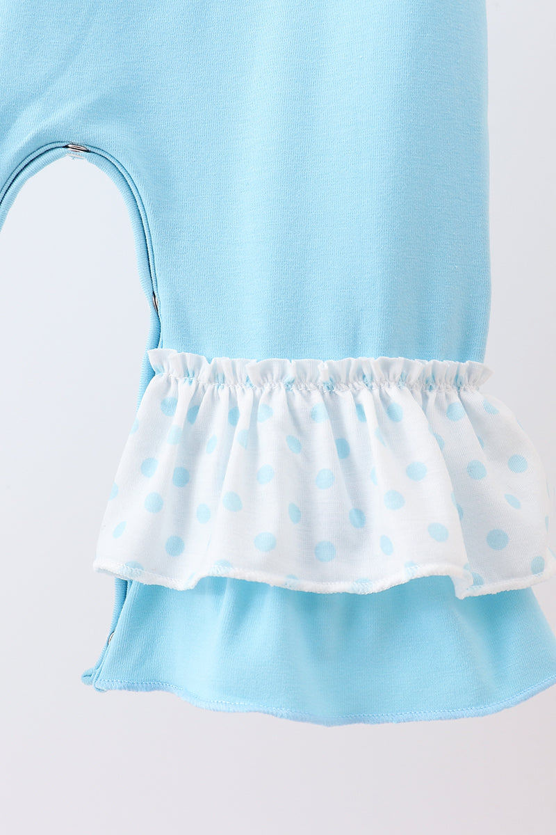 Light blue dress with white ruffled trim on a light gray background