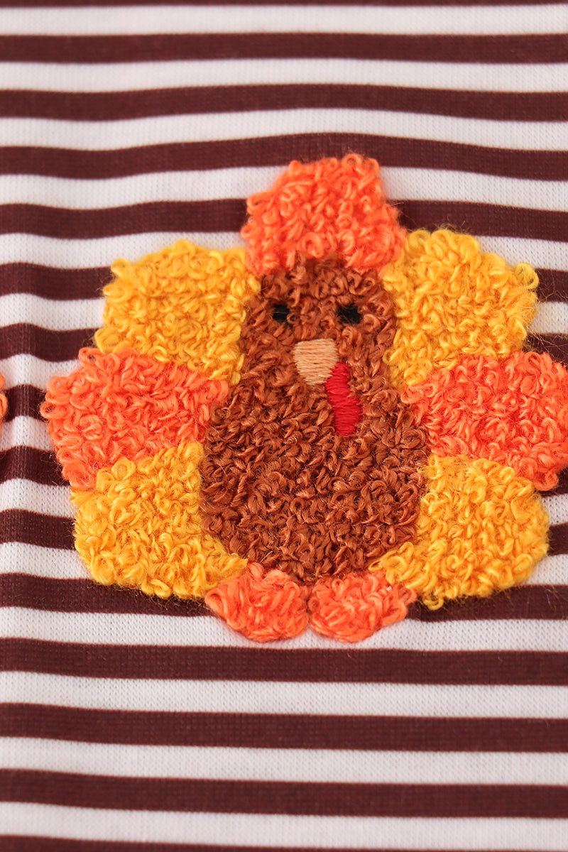 Striped fabric with a colorful turkey applique