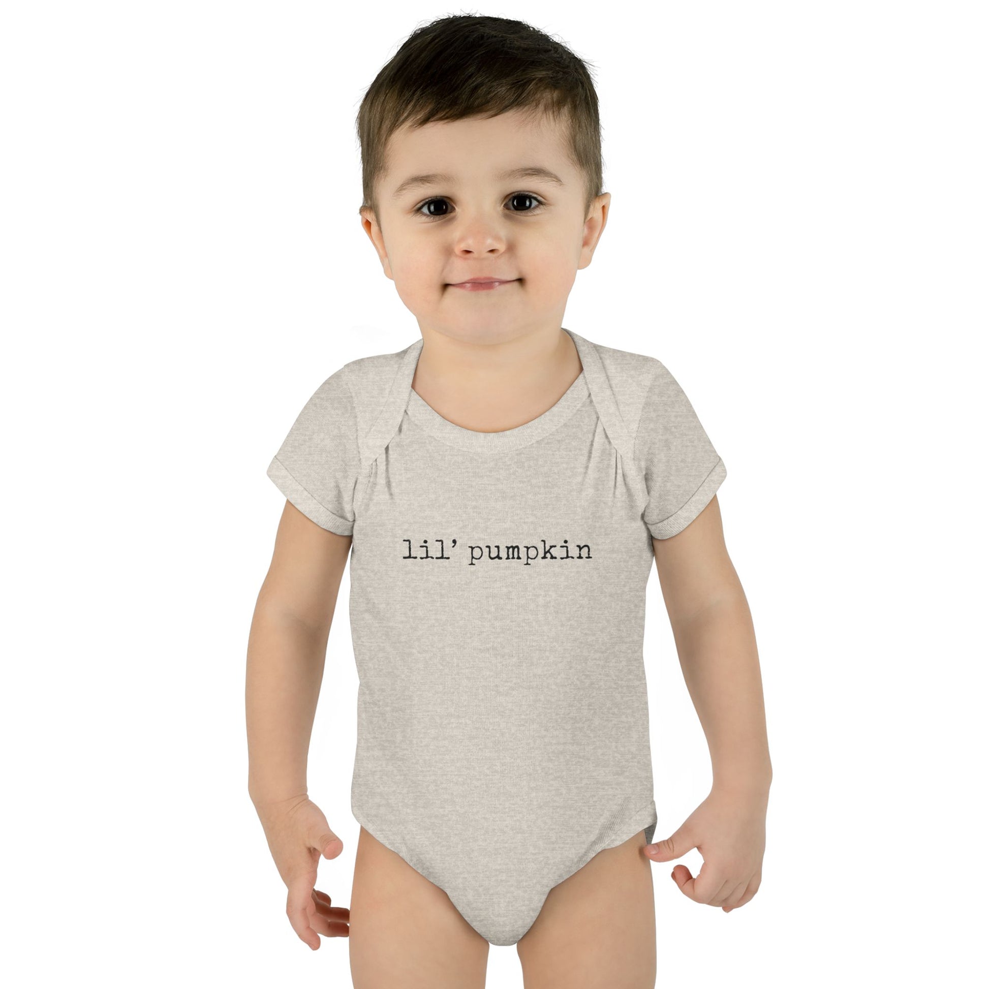 Child wearing a gray onesie with 'lil' pumpkin text on a white background