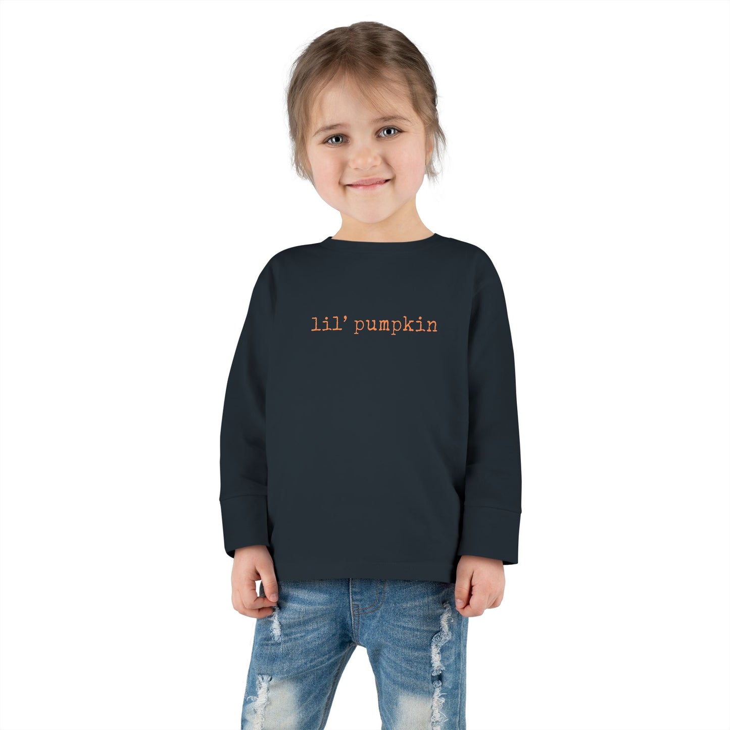 Child wearing a black sweatshirt with 'lil' pumpkin' text on a white background