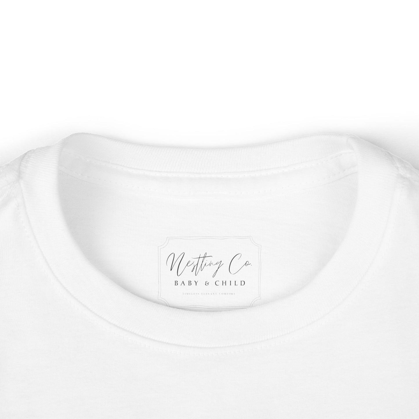 White t-shirt with 'Nesting Co Baby & Child' logo on a white background