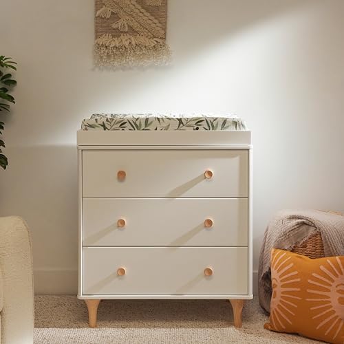 White dresser with three drawers in a room setting with a plant and pillow.