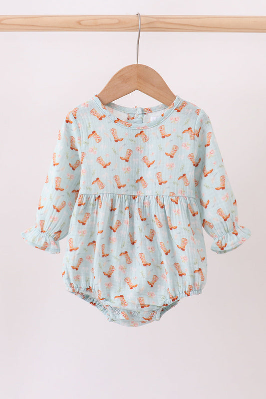 Baby romper with fox pattern on a wooden hanger against a light pink background