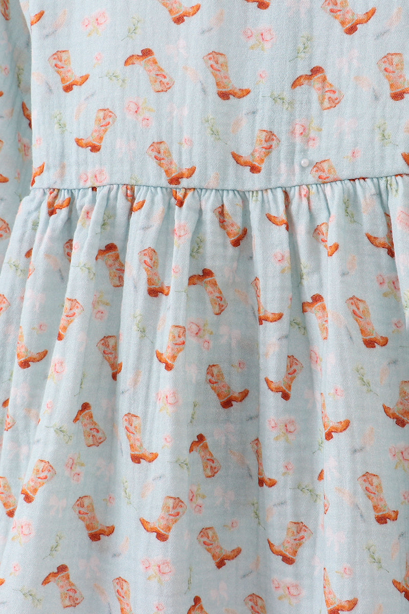 Dress with cowboy boot pattern on a light blue background