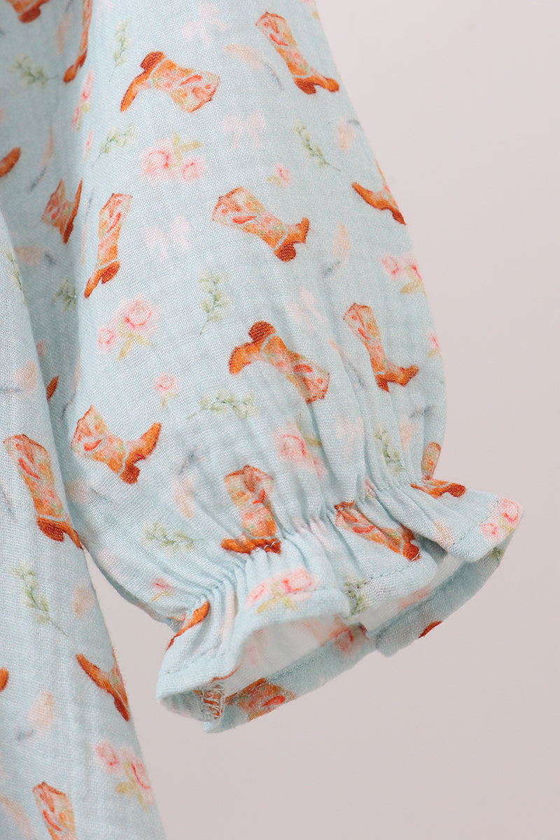 Light blue fabric with orange floral pattern on a plain background